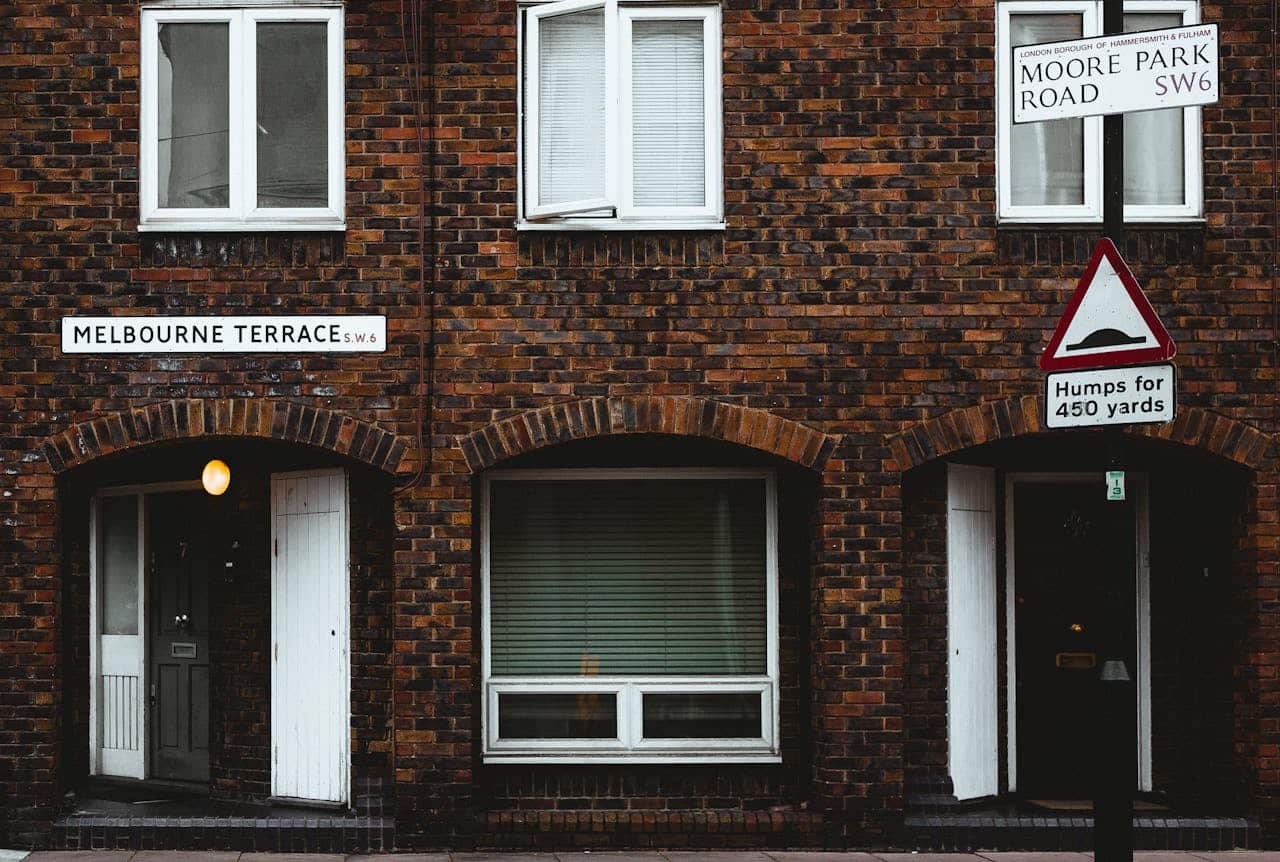 Exterior view of a brick building with Melbourne Terrace sign in London.