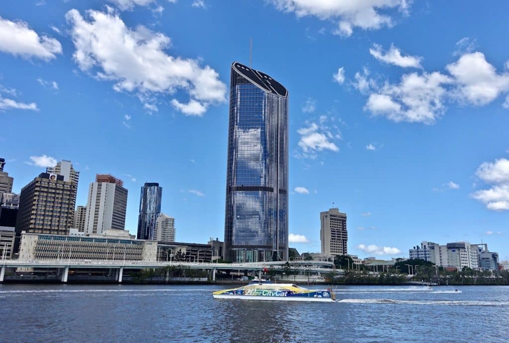 A stunning view of Brisbane's city skyline with modern buildings and a clear blue sky.