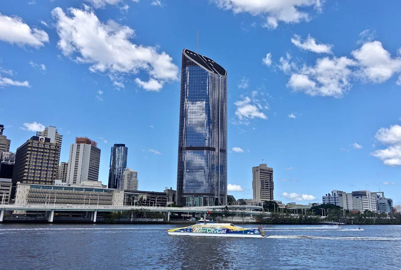A stunning view of Brisbane's city skyline with modern buildings and a clear blue sky.