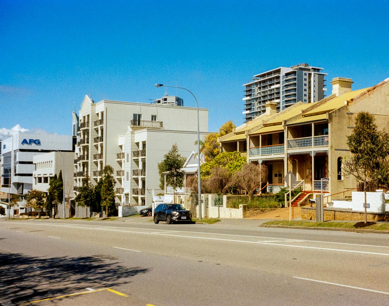 A street view showcasing a mix of historical and modern buildings in an urban setting.