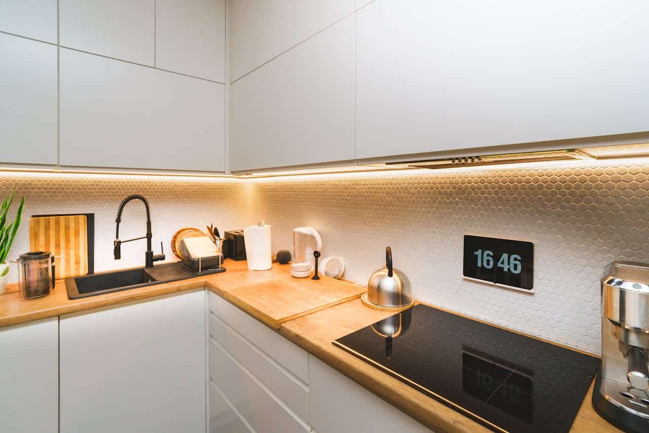 A sleek modern kitchen with wooden countertops and stylish appliances.