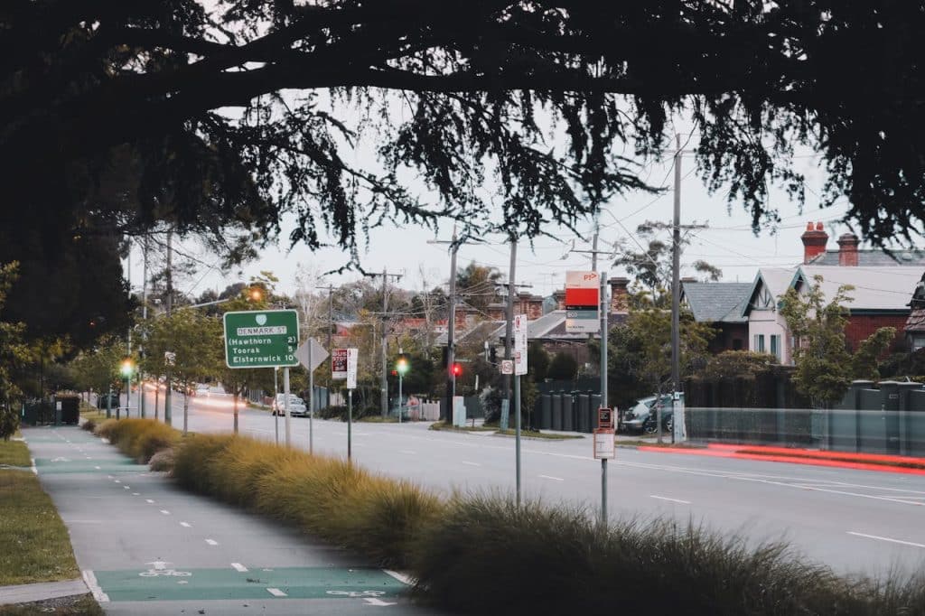 A street view in Melbourne showing traffic signs and residential buildings.