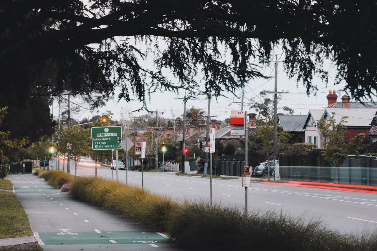 A street view in Melbourne showing traffic signs and residential buildings.