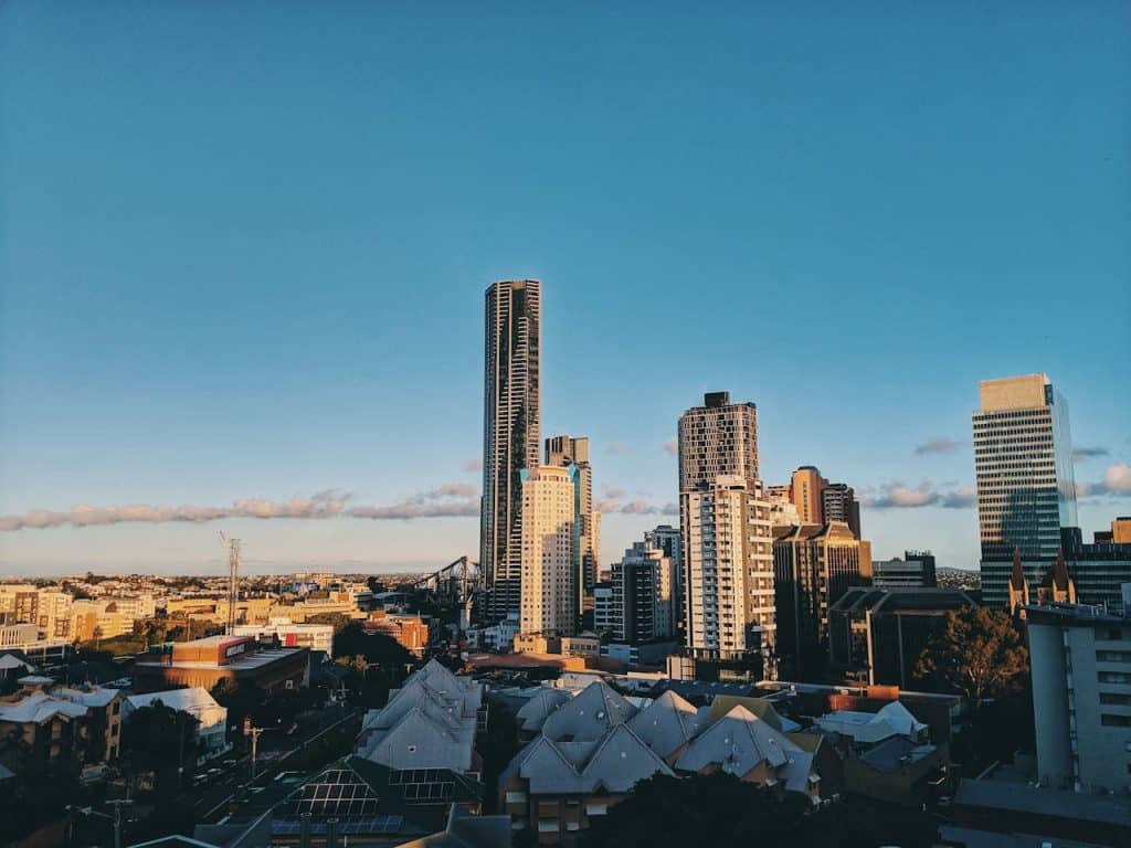 A panoramic view of Brisbane's city skyline with tall buildings under a clear blue sky.