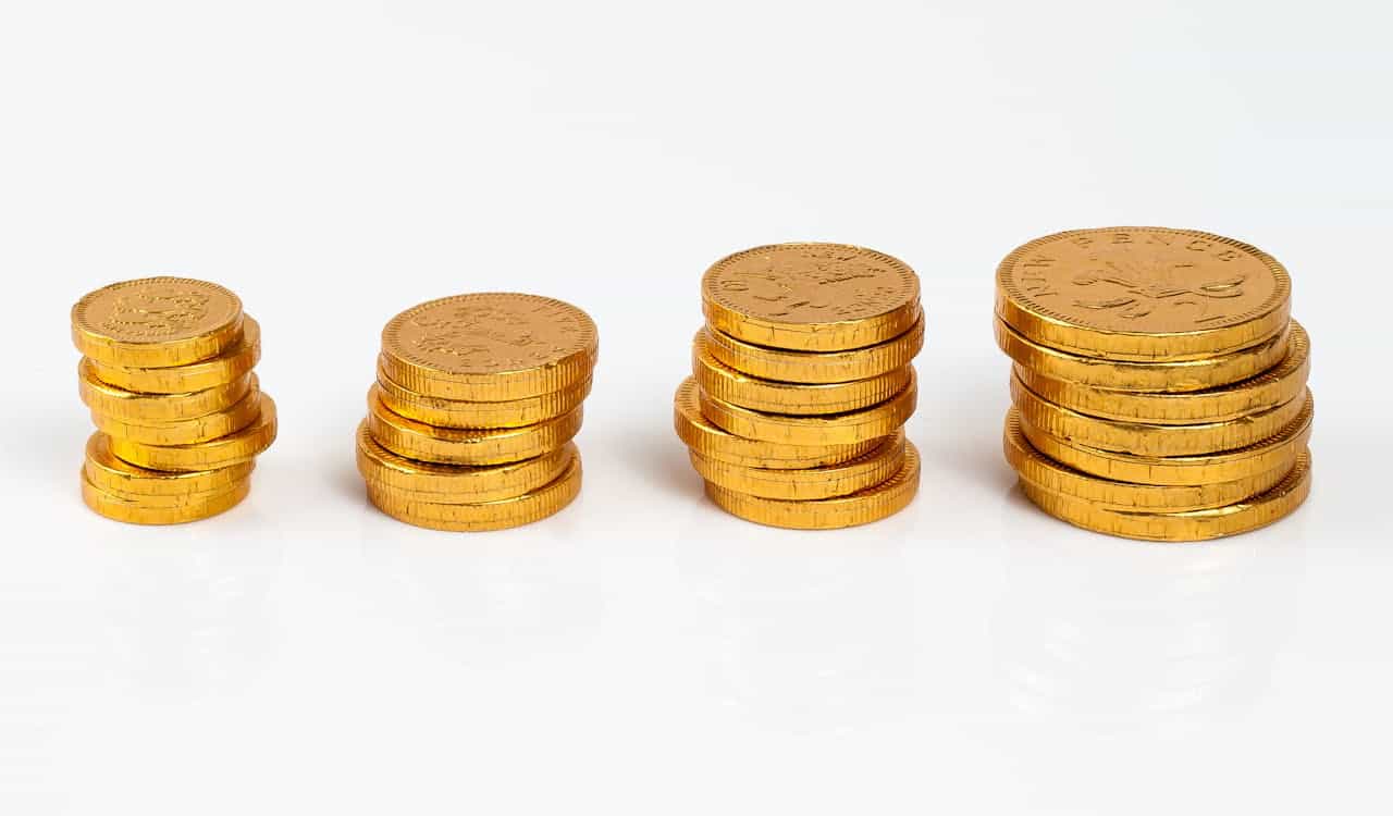 Stacked gold coins showcasing varying sizes.