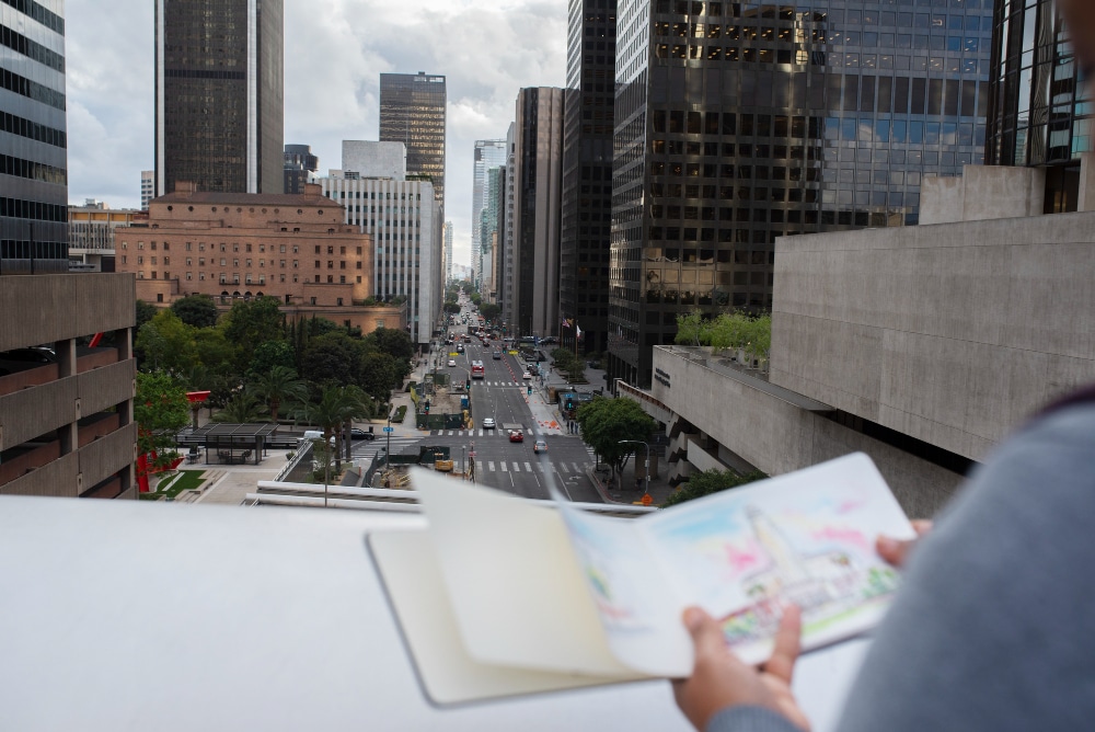 A sketch of a modern city skyline being created from a rooftop perspective.